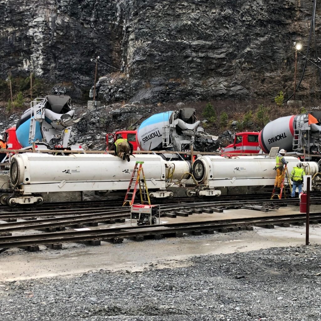 Mixer trucks pouring into a tunnel boring machine