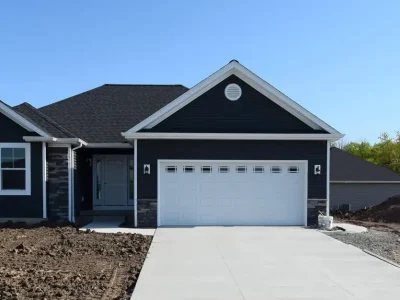 A one-story home with freshly paved driveway.