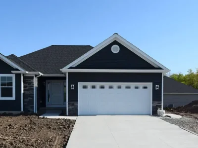 A one-story home with freshly paved driveway.